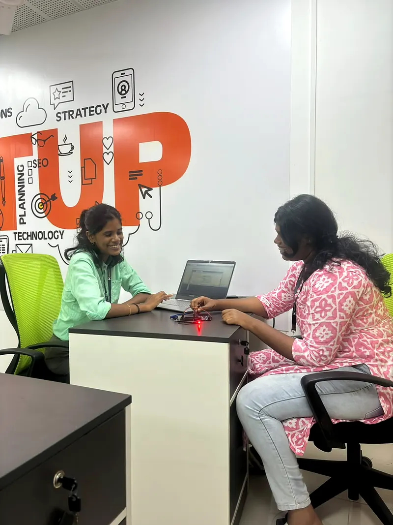 Two engineers bringing up a circuit board at a desk
