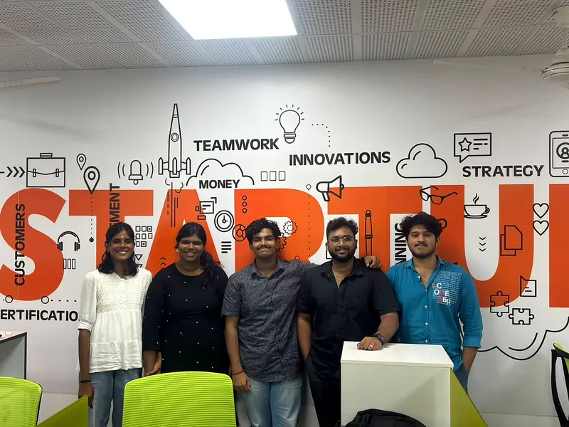 The Nexospark team in front of the Startup wall
